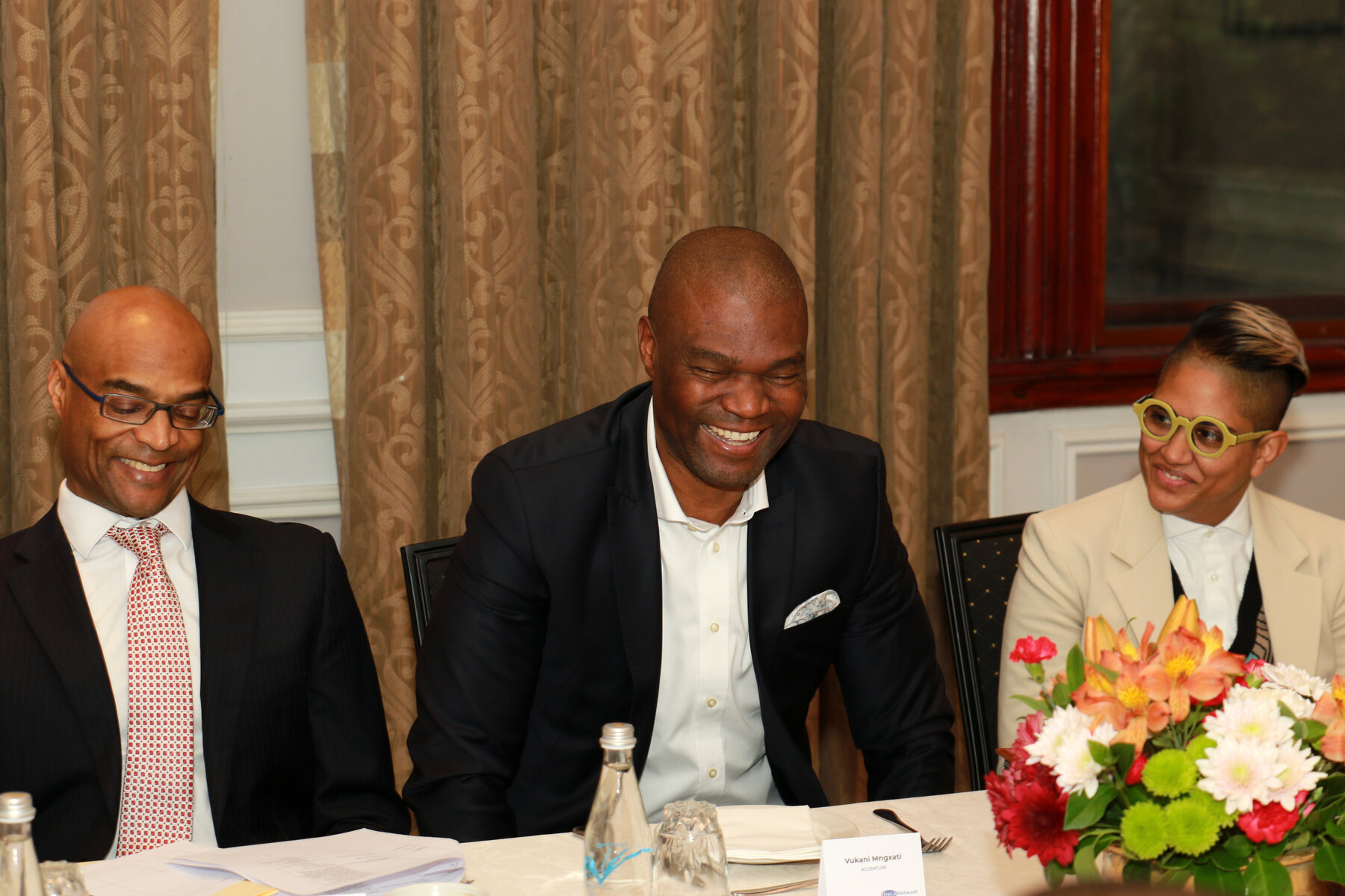 Senior leaders sharing a warm exchange at a Hela session
